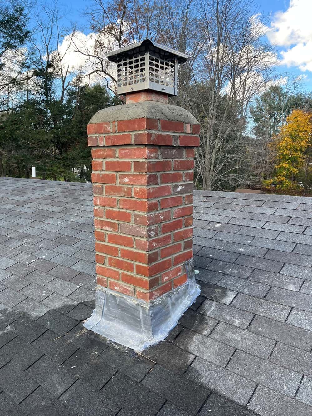 Rebuilt brick chimney with new concrete crown and stainless cap