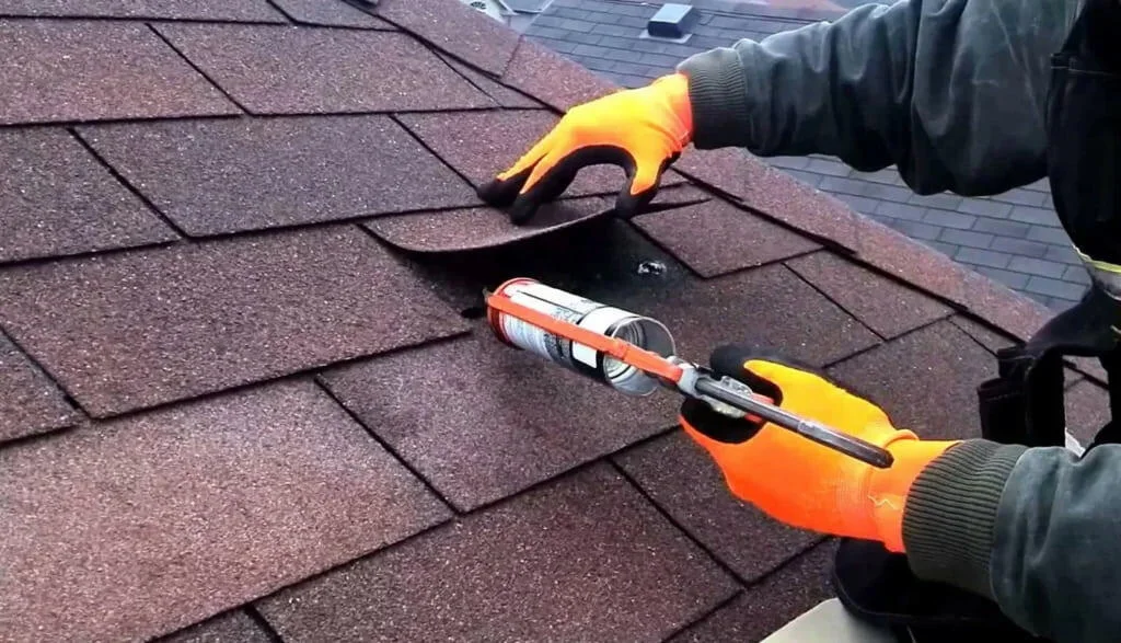 Sealing lifted shingles during a roof repair in Washington DC